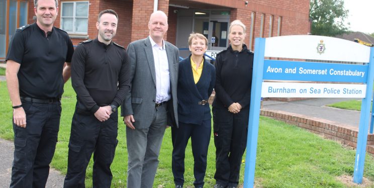 Clare is stood with 4 other people next to a police station sign for Burnham on Sea station