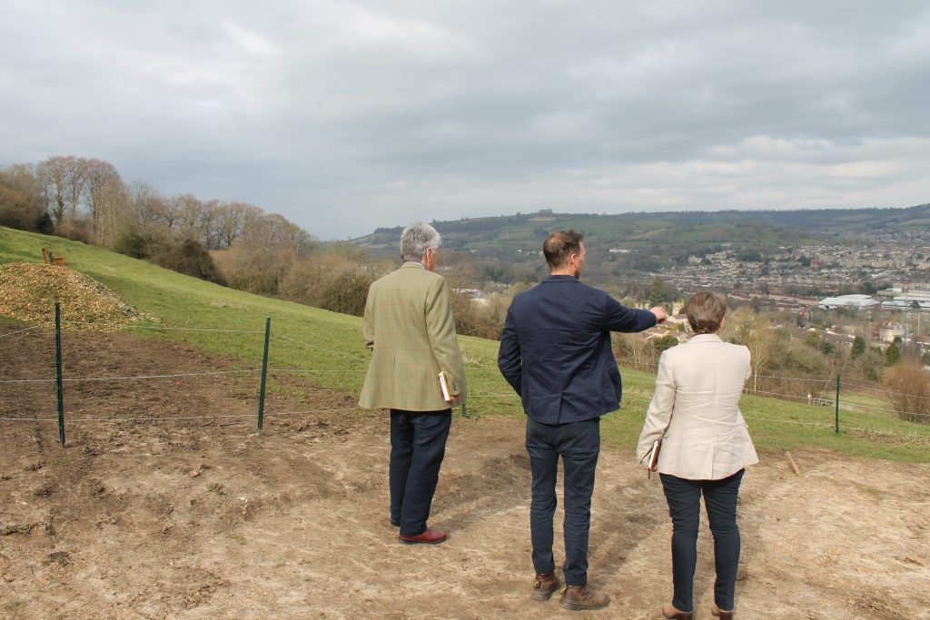 An image of Thomas Sheppard Chair of Trustees and Farm Director Brendan Wistreich showing Clare the Farm